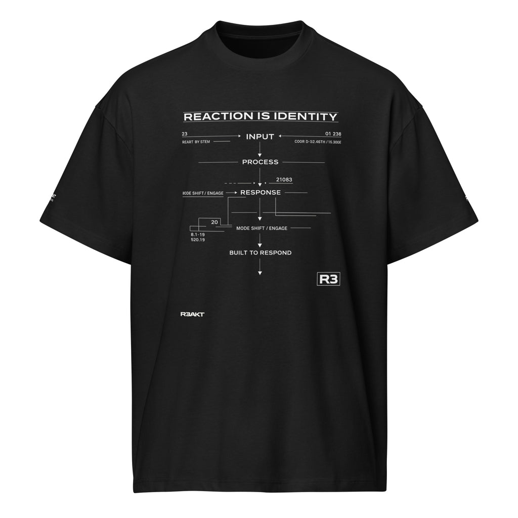 REAKT R3 black oversized T-shirt featuring a white technical flowchart graphic with the text "Reaction Is Identity", "Input", "Process", "Response", and "Built to Respond" printed on the front

